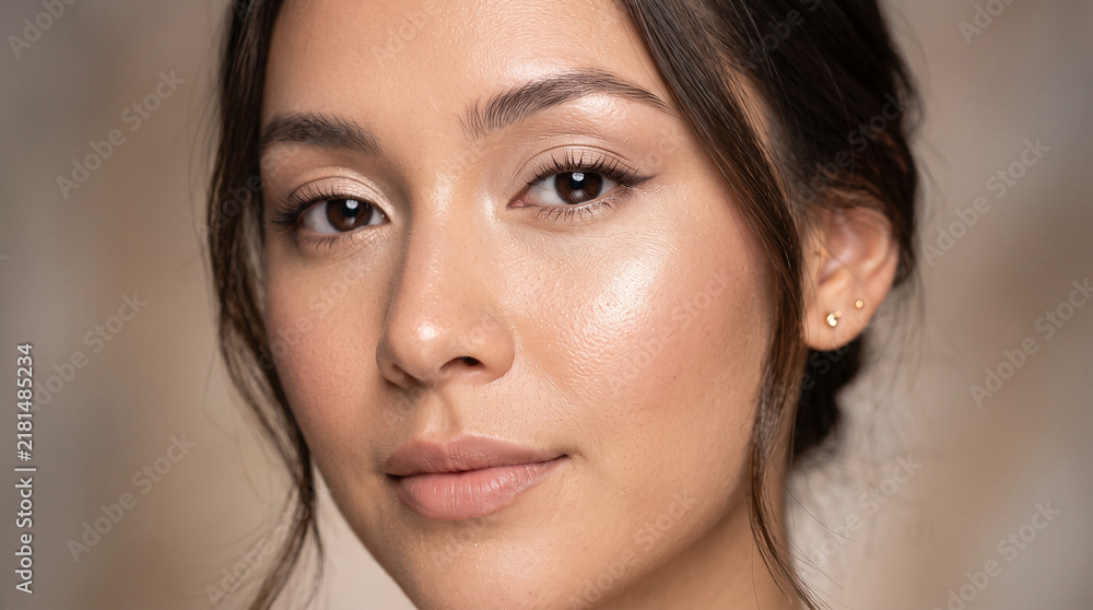 Fototapeta premium Close-up portrait of young woman with natural makeup and glowing skin
