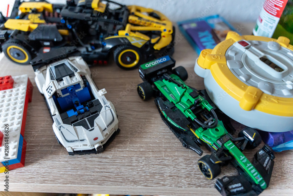 Obraz premium Warsaw, Poland - Sep 4, 2026: LEGO Technic model cars and construction vehicle displayed on a wooden shelf