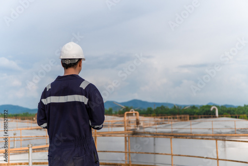 Environmental engineering using digital tablet check report environment clean air of air pollution reduction industrial plants. Engineer analysis sustainable energy saving with sky sunset. ESG. CEMS
