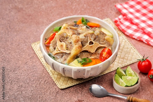 Bild auf Leinwand Sop buntut or oxtail soup, a traditional Indonesian oxtail soup made with tender beef oxtail simmered in a rich and flavorful broth with vegetables and aromatic spices