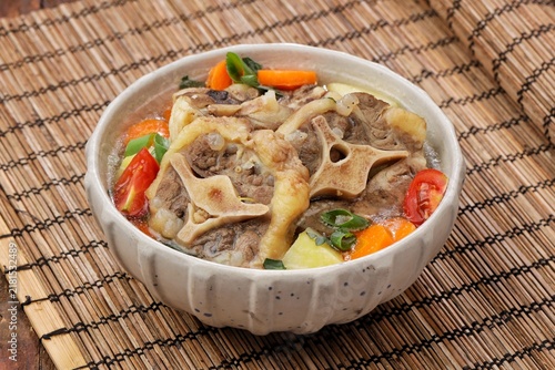 Obraz na plátně Sop buntut or oxtail soup, a traditional Indonesian oxtail soup made with tender beef oxtail simmered in a rich and flavorful broth with vegetables and aromatic spices