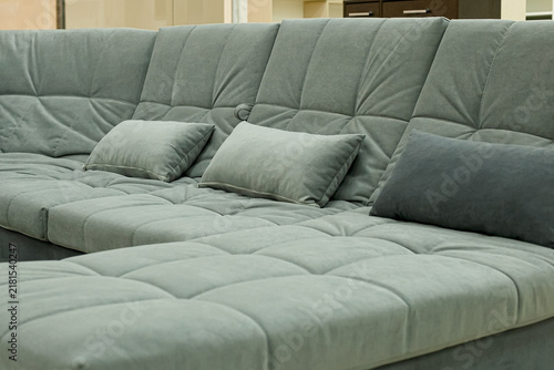 A modern sofa in the showroom of an upholstered furniture store.