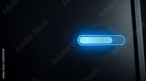 Glow progress bar loading symbol indicator on dark digital electronic device display screen