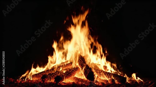 A dramatic isolated fire burning against a completely black background. The flames are dominated by rich red, dark orange, bright orange, and golden yellow tones, creating a powerful cinematic atmosph