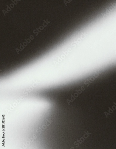 Abstract grainy black and white background with diagonal gradient light streak, retro film noise texture and dramatic monochrome aesthetic