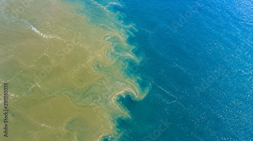 River delta confluence aerial view of muddy water meeting blue ocean