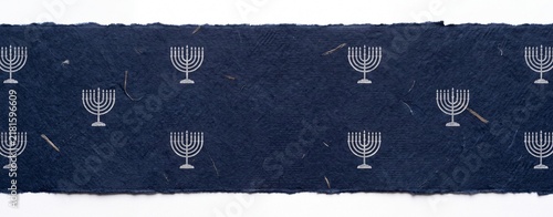 An elegant navy blue textile features a repeating pattern of minimalist silver menorahs, evoking a sense of tradition and spiritual celebration.