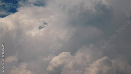 White puffy clouds drifting across a bright blue sky during a sunny afternoon capturing nature in motion