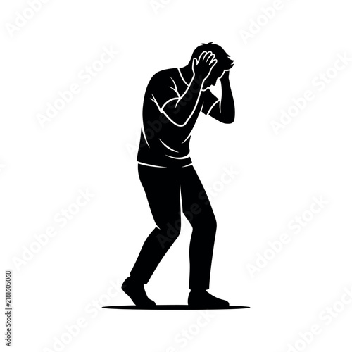 Silhouette of a man in distress holding his head in his hands.