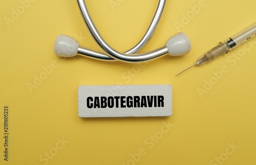 Canvastavla Healthcare and medical concept with text CABOTEGRAVIR, stethoscope and syringe on yellow background