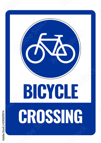 Fotografie Blue bicycle crossing sign indicating a designated cycling route or crossing area, alerting road users to watch for bicycles and prioritize cyclist safety