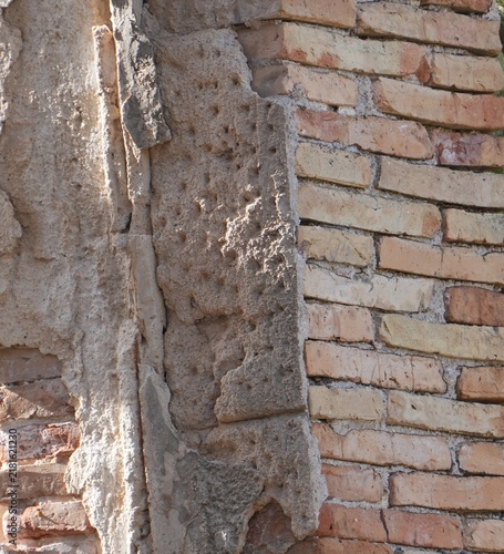 Картината върху платно Exposed brick wall with deteriorated plaster and old masonry detail