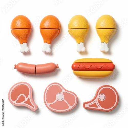 Collection of plastic toy food pieces for children playing.