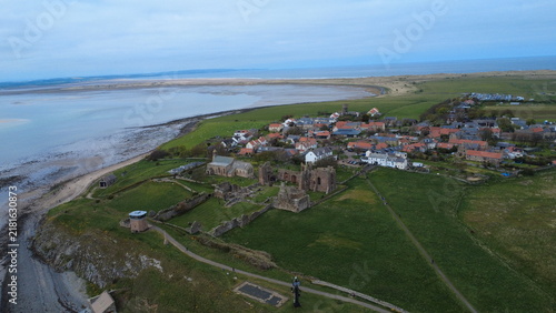 Canvas Print Aerial view of Lindisfarne Priory, St Mary's Church, and Holy Island village wit
