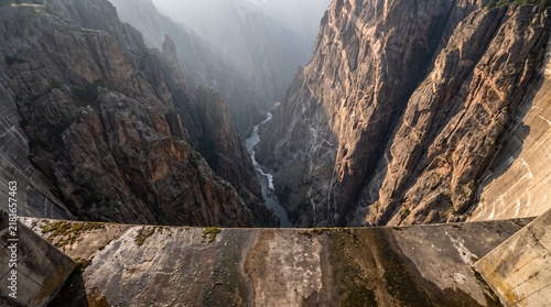 Breathtaking High Altitude View Looking Down Into a Deep Rugged Mountain Canyon Gorge with a Winding River Flowing Through the Rocky Valley Floor