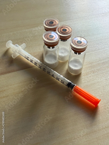 Reta, retatrutide peptide in a vial and bacteriostatic water on a wooden background