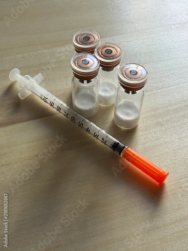 Reta, retatrutide peptide in a vial and bacteriostatic water on a wooden background