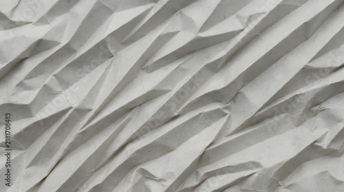 White crumpled paper texture background with sharp geometric folds and shadows.