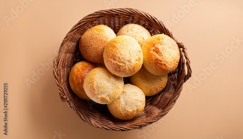 brazilian cheese bread in a rustic basket isolated aerial top view on beige background