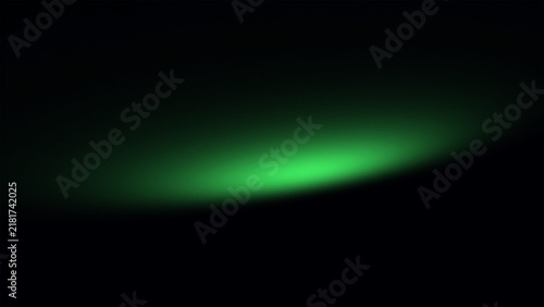Soft glowing green light beam on a dark black background