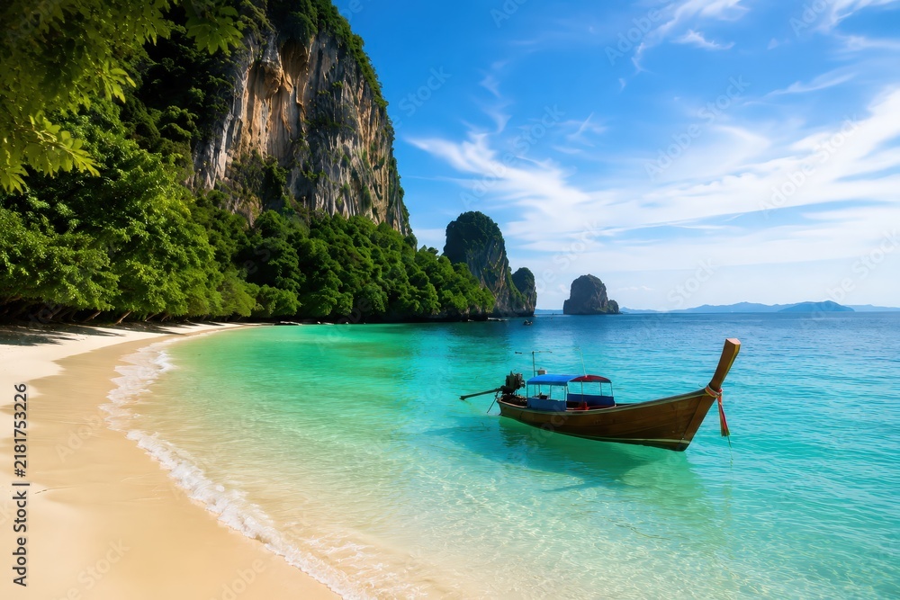 Obraz premium Turquoise Cove Long Tail Boat Tropical Beach Travel Paradise Thailand, Traditional long tail boat floats in a turquoise cove beside limestone cliffs during a sunny tropical vacation