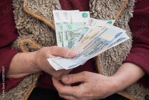 Elderly woman counting russian rubles illustrating high inflation and rising prices in 2026