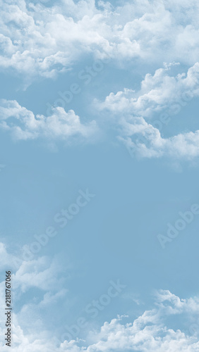 Soft Blue Sky with Fluffy White Clouds and Large Copy Space.