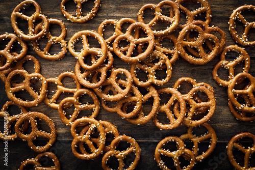 Oktoberfest Pretzel mini salted crunchy brezel snack crackers scattered on dark wooden background table