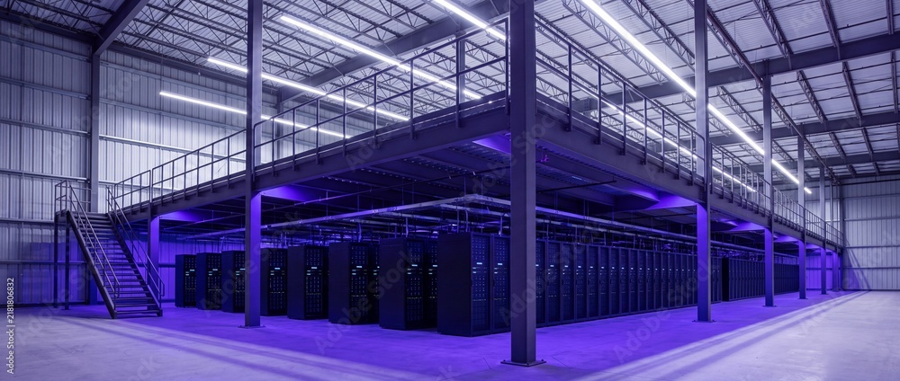 Obraz premium Modern Data Center Interior with Server Racks Under Purple Lighting and Steel Mezzanine Platform