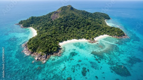Aerial view of a tropical island in the blue ocean