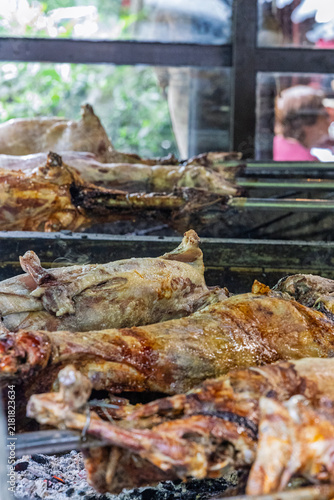 Whole Roasted Lamb On Spit Over Hot Coals At Traditional Outdoor Barbecue Roast