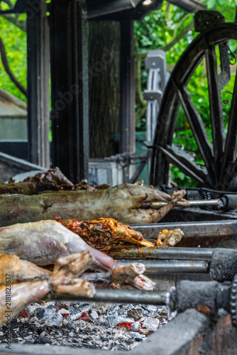 Whole Roasted Lamb On Spit Over Hot Coals At Traditional Outdoor Barbecue Roast