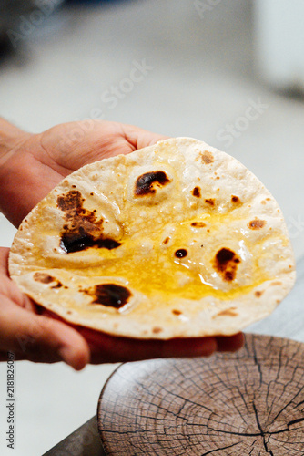 hand holding indian naan bread