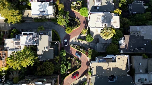 Iconic lombard street in san francisco seen from an aerial top down perspective. Cars driving down the famous crooked road on a sunny day