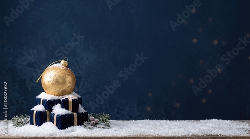 3d Christmas Day abstract background new 2026 Golden christmas bauble on blue gift boxes with snow and pine branches illustration