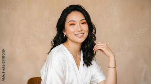 Attractive young asian woman looking beautifully at camera in studio perfect for trendy fashion styling and professional cosmetic beauty care