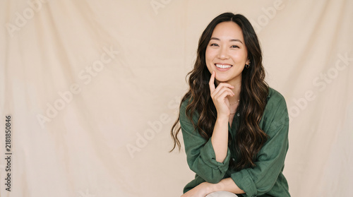 Cheerful asian businesswoman posing confidently with elegant modern style perfect for professional corporate portraits and successful job careers