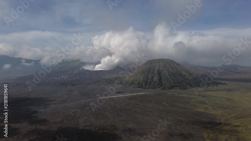 Active mount bromo volcano erupting smoke and ash next to mount batok in east java, indonesia