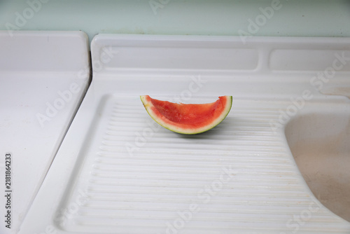 single watermelon rind on white counter
