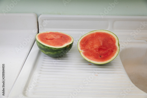 watermelon cut in half on white counter