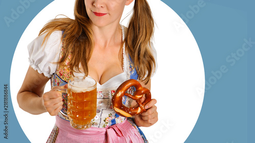 Obraz na plátně A beautiful young woman in traditional german dress holds a beer and pretzel iso