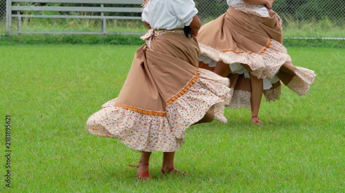Woman spinning in traditional dress during folkloric dance performance