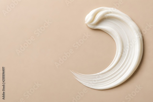 Crescent Shaped White Skincare Cream Swatch on Beige with Copy Space