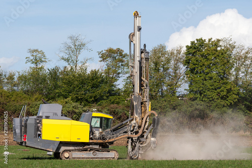 Brutal power for clean energy. A mobile drilling rig kicks up dust while preparing the field for the photovoltaic future.