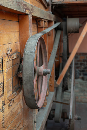 Fotografie Close-up of a flat belt on a pulley of an old threshing machine.
