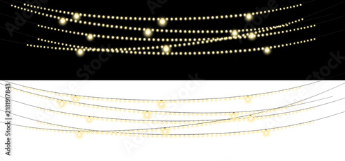 Strings of glowing yellow bulb lights on black