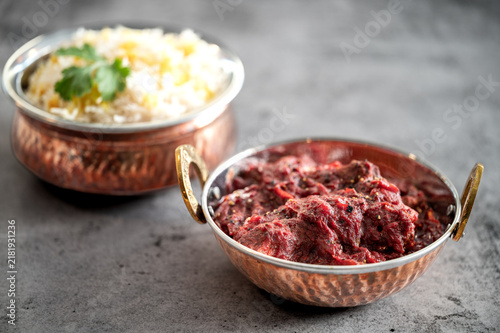 Traditional Indian vag and chicken curry served with naan flat bread. Indian curry, chicken tikka masala with rice and naan bread. Dark background. Copy space.