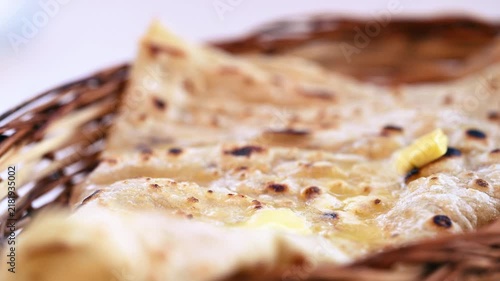 Naan bread on dark background close-up. Paratha and roti. Indian bread 4K video. Chapati and butter naan.