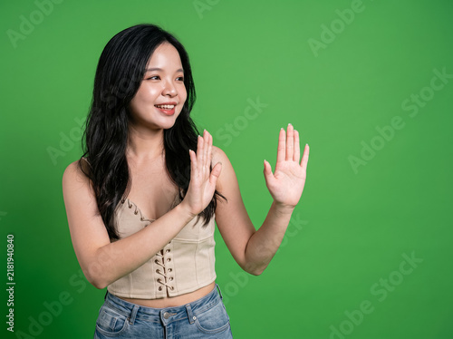 Photography Woman gesturing in front of green screen background