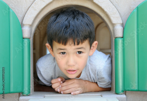 фотографія closeup one little boy playing on a playscape
